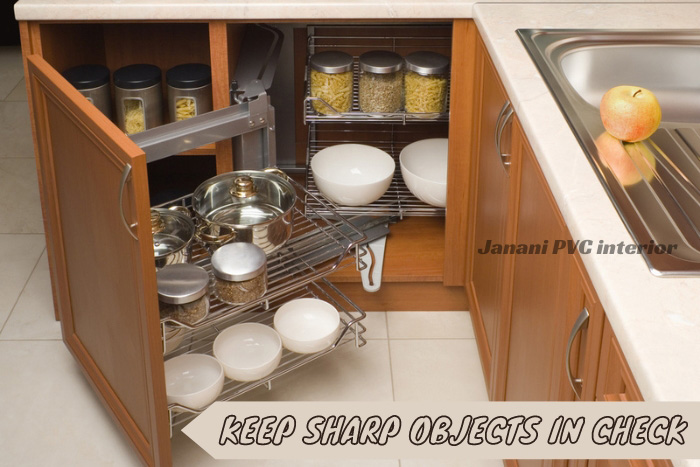 Well-organized kitchen cabinet from Janani PVC Interior featuring secure storage for sharp kitchen tools, ensuring the safety and longevity of PVC cabinetry for Bengaluru households