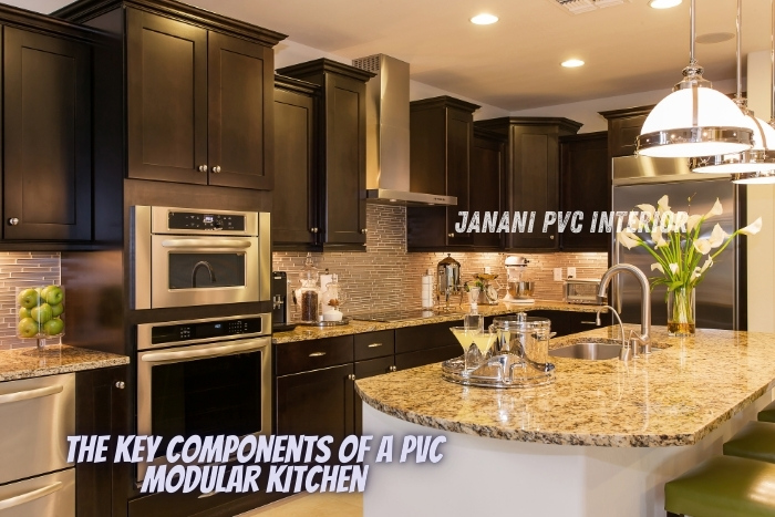 Spacious and modern PVC modular kitchen designed by Janani PVC Interior in Bengaluru, featuring dark cabinetry, granite countertops, and stylish appliances, highlighting the key components of durability and design excellence